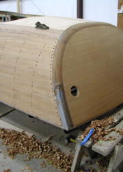 Hand shaping the cover board on a Riva Tritone Aperto